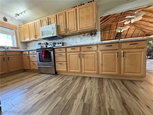 1829 Campton St, Ely, NV 89301 - kitchen with white microwave, stainless steel electric range, light wood-style floors, tasteful backsplash, and ceiling fan