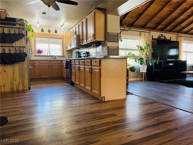 1829 Campton St, Ely, NV 89301 - kitchen with dark wood-type flooring, ceiling fan, backsplash, and brown cabinets