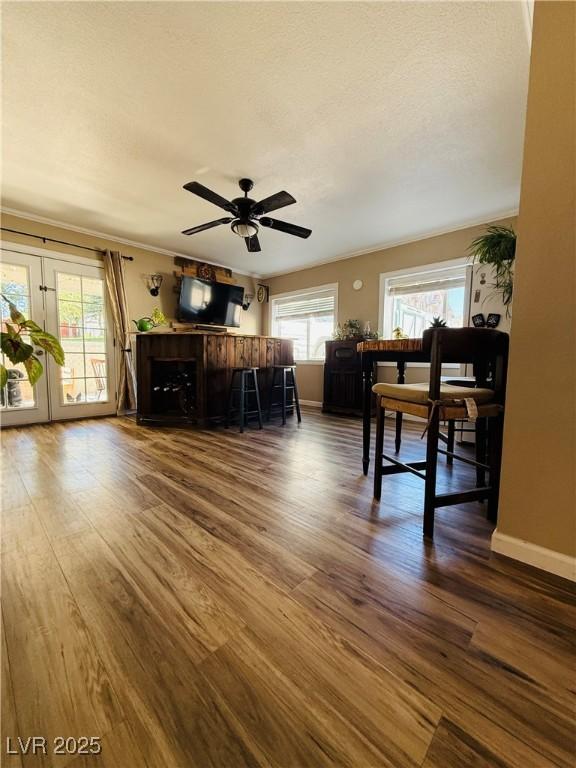 1829 Campton St, Ely, NV 89301 - living area with dark wood-style floors, ceiling fan, french doors, and crown molding