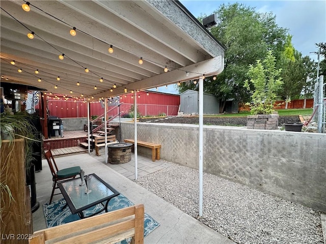 1829 Campton St, Ely, NV 89301 - view of patio with a shed, a fire pit, and a wooden deck