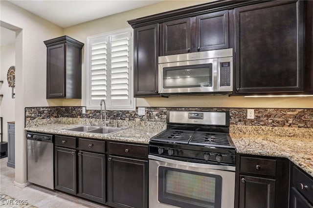 7407 Bakewell Ave, Las Vegas, NV 89179 - kitchen with appliances with stainless steel finishes, dark brown cabinets, and light stone counters