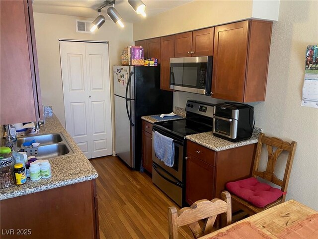 2750 S Durango Dr Unit 2141, Las Vegas, NV 89117 - kitchen with stainless steel appliances, dark wood-style floors, and brown cabinets