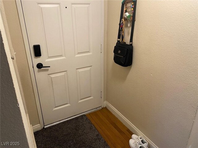 2750 S Durango Dr Unit 2141, Las Vegas, NV 89117 - doorway to outside featuring dark wood-style flooring and a textured wall