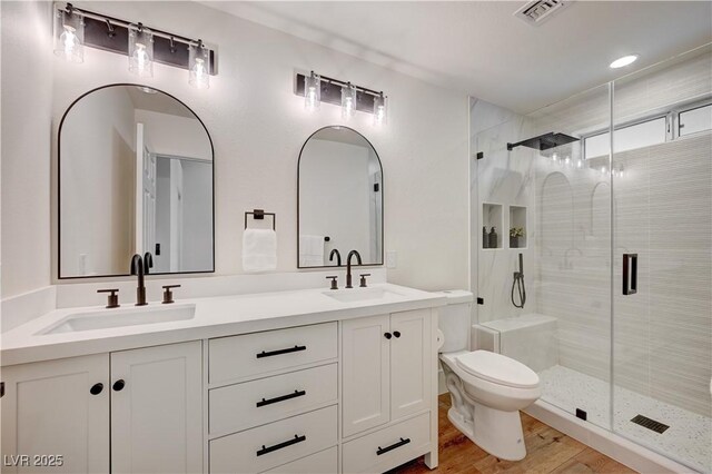 8813 Sundial Dr, Las Vegas, NV 89134 - full bath featuring a stall shower, double vanity, and wood finished floors