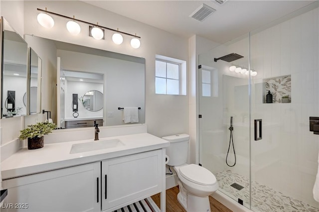 8813 Sundial Dr, Las Vegas, NV 89134 - bathroom with a stall shower, vanity, and wood finished floors