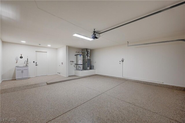 8813 Sundial Dr, Las Vegas, NV 89134 - garage featuring strapped water heater, a garage door opener, and recessed lighting