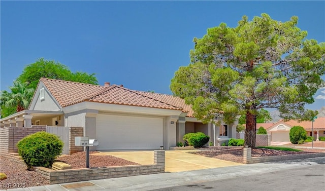 8813 Sundial Dr, Las Vegas, NV 89134 - view of front of house with a tile roof, a garage, driveway, and stucco siding