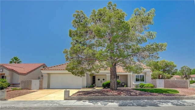 8813 Sundial Dr, Las Vegas, NV 89134 - view of front of house with stucco siding, an attached garage, driveway, and a tile roof