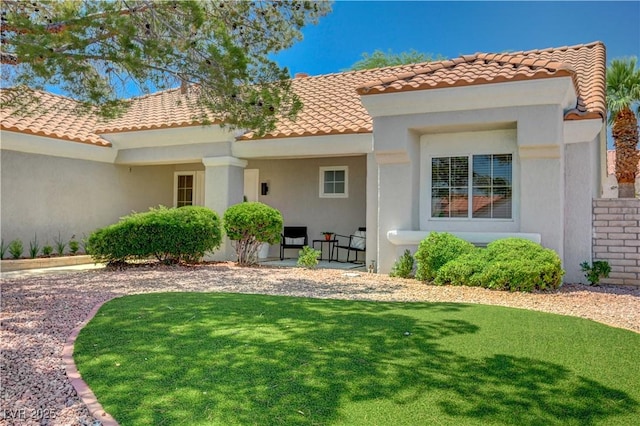 8813 Sundial Dr, Las Vegas, NV 89134 - back of house with a tile roof, a lawn, and stucco siding
