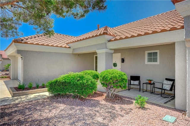 8813 Sundial Dr, Las Vegas, NV 89134 - view of exterior entry featuring a tiled roof and stucco siding