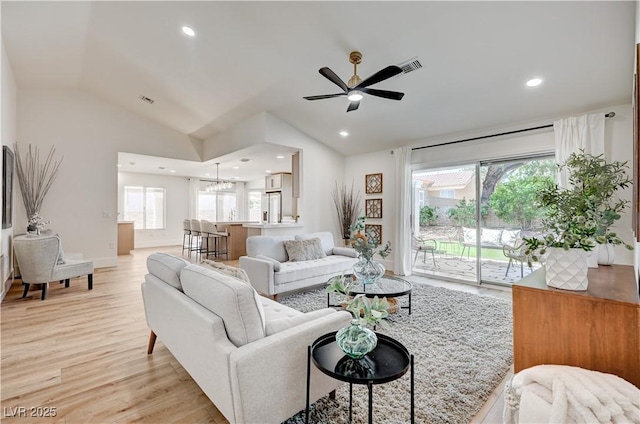 8813 Sundial Dr, Las Vegas, NV 89134 - living room with a ceiling fan, light wood-style floors, lofted ceiling, a chandelier, and recessed lighting