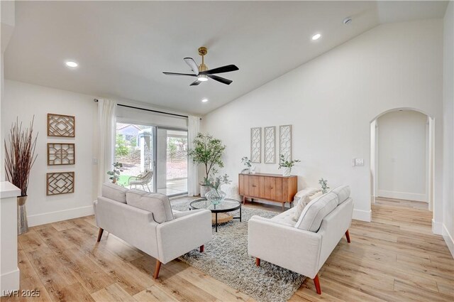 8813 Sundial Dr, Las Vegas, NV 89134 - living room with arched walkways, a ceiling fan, light wood-style flooring, recessed lighting, and high vaulted ceiling
