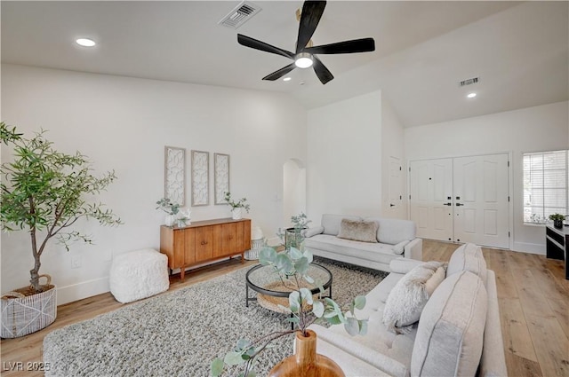 8813 Sundial Dr, Las Vegas, NV 89134 - living area featuring lofted ceiling, arched walkways, wood finished floors, a ceiling fan, and recessed lighting