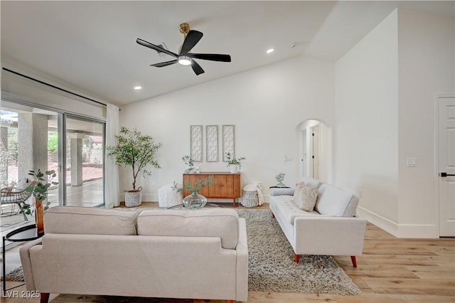 8813 Sundial Dr, Las Vegas, NV 89134 - living area with a ceiling fan, arched walkways, light wood-type flooring, recessed lighting, and high vaulted ceiling