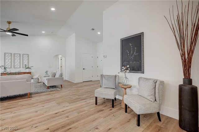 8813 Sundial Dr, Las Vegas, NV 89134 - sitting room with arched walkways, ceiling fan, high vaulted ceiling, light wood-type flooring, and recessed lighting