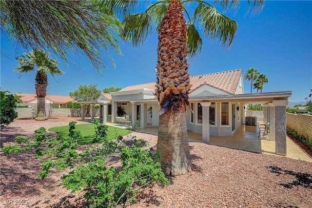 8813 Sundial Dr, Las Vegas, NV 89134 - rear view of property with a patio area, a fenced backyard, a tile roof, and stucco siding