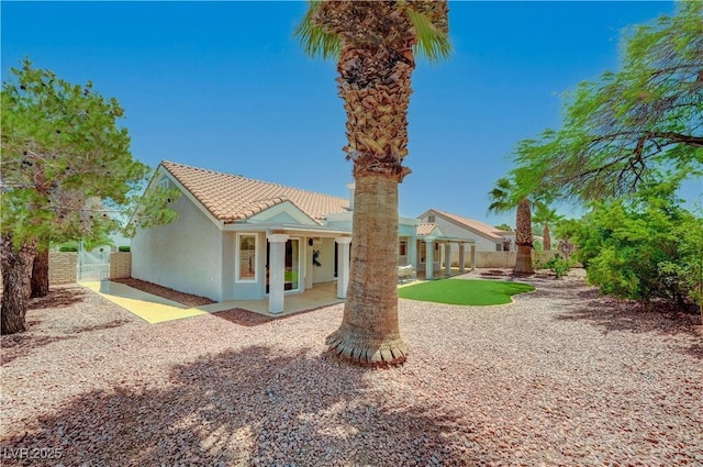 8813 Sundial Dr, Las Vegas, NV 89134 - back of property with stucco siding, a patio, a gate, and a tiled roof