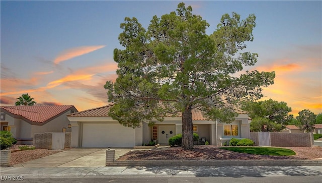 8813 Sundial Dr, Las Vegas, NV 89134 - view of front of property with concrete driveway, stucco siding, a garage, and a tiled roof