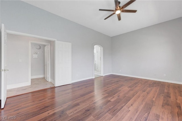 3079 Evening Mist Ave, Henderson, NV 89052 - empty room with ceiling fan, arched walkways, and wood finished floors