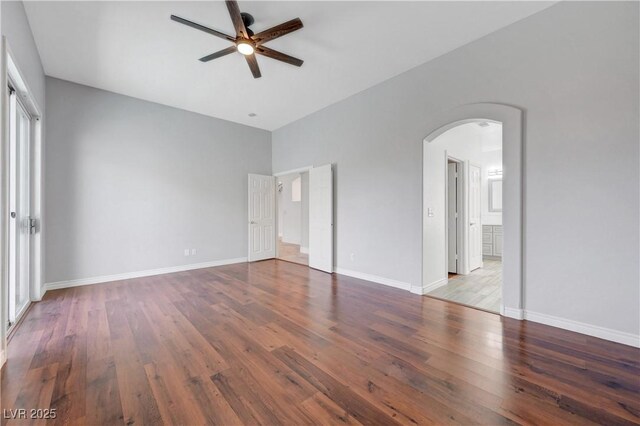 3079 Evening Mist Ave, Henderson, NV 89052 - unfurnished bedroom featuring arched walkways, wood finished floors, ensuite bath, and ceiling fan