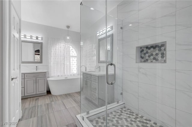 3079 Evening Mist Ave, Henderson, NV 89052 - bathroom with vanity, a soaking tub, a stall shower, and a chandelier