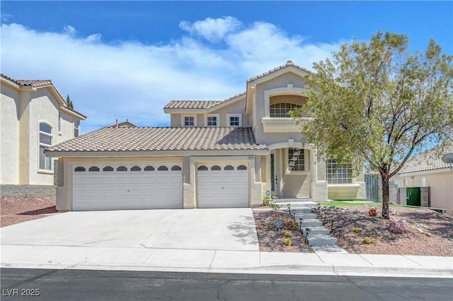 3079 Evening Mist Ave, Henderson, NV 89052 - mediterranean / spanish-style home featuring a garage, a tile roof, driveway, and stucco siding