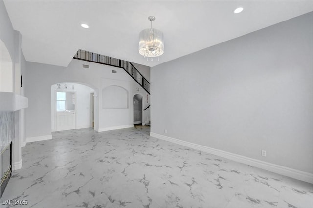3079 Evening Mist Ave, Henderson, NV 89052 - unfurnished living room featuring arched walkways, light marble finish floors, a chandelier, and recessed lighting