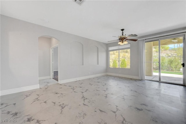 3079 Evening Mist Ave, Henderson, NV 89052 - spare room featuring arched walkways, a ceiling fan, and light marble finish floors
