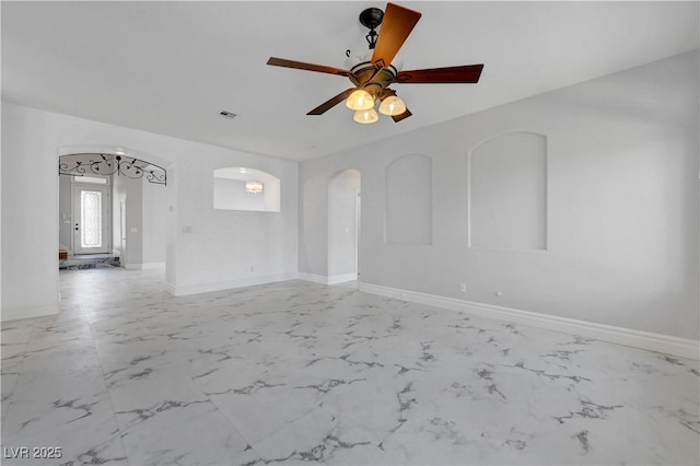 3079 Evening Mist Ave, Henderson, NV 89052 - empty room with light marble finish flooring, a ceiling fan, and arched walkways