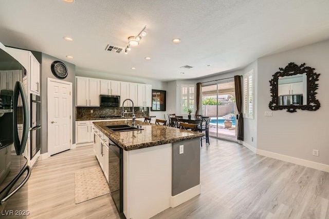6103 Sundown Crest St, Las Vegas, NV 89113 - kitchen featuring stainless steel microwave, dishwasher, recessed lighting, light wood finished floors, and white cabinetry
