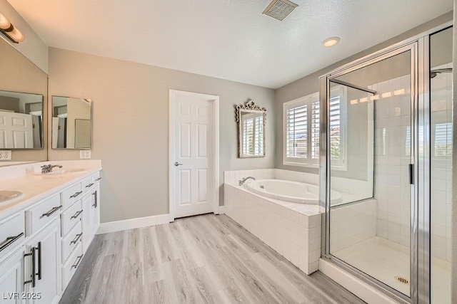 6103 Sundown Crest St, Las Vegas, NV 89113 - full bathroom with a garden tub, wood finished floors, double vanity, a stall shower, and recessed lighting