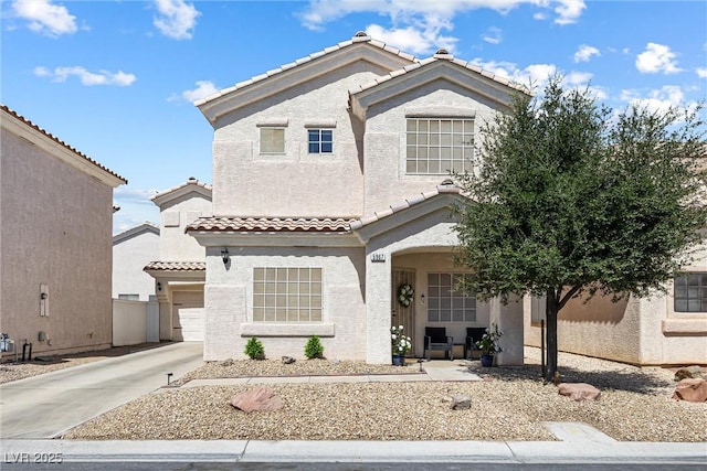 5967 Aimless St, Henderson, NV 89011 - view of front of home featuring a tiled roof, stucco siding, driveway, and a garage