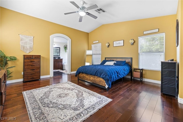 5967 Aimless St, Henderson, NV 89011 - bedroom featuring lofted ceiling, dark wood-style floors, arched walkways, ceiling fan, and ensuite bath