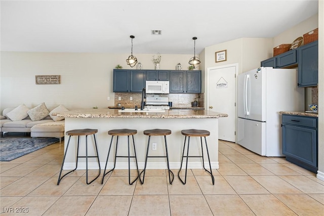 5967 Aimless St, Henderson, NV 89011 - kitchen featuring white appliances, backsplash, a breakfast bar area, and light tile patterned flooring