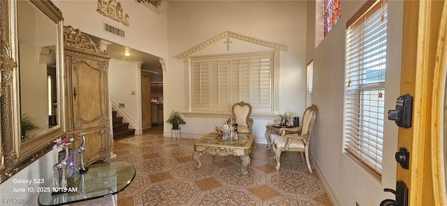 6275 Allspice Ct, Las Vegas, NV 89142 - living area with a towering ceiling and stairway