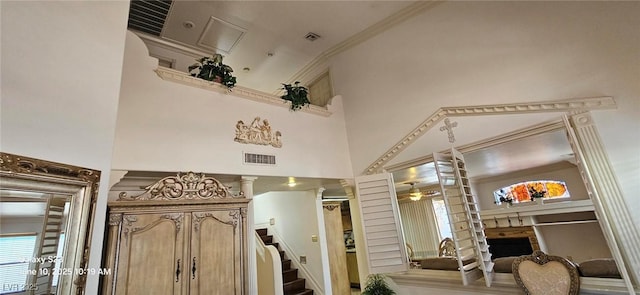 6275 Allspice Ct, Las Vegas, NV 89142 - foyer with a high ceiling, a fireplace, a ceiling fan, and ornamental molding