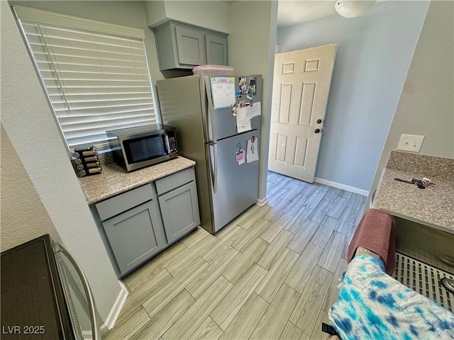 2016 Mesquite Ln Unit 302, Laughlin, NV 89029 - kitchen with appliances with stainless steel finishes, wood tiled floors, and gray cabinetry