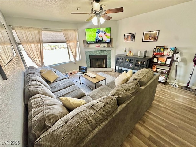 2016 Mesquite Ln Unit 302, Laughlin, NV 89029 - living room with ceiling fan, wood finished floors, and a tiled fireplace