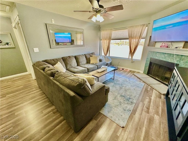 2016 Mesquite Ln Unit 302, Laughlin, NV 89029 - living room with wood finished floors, ceiling fan, and a tiled fireplace