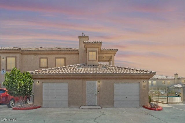 3608 Quetonia St Unit 204, Las Vegas, NV 89108 - townhome / multi-family property featuring driveway, a chimney, a tiled roof, and stucco siding
