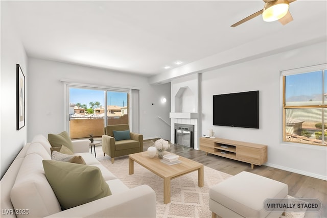3608 Quetonia St Unit 204, Las Vegas, NV 89108 - living area with light wood-type flooring, ceiling fan, and a tiled fireplace
