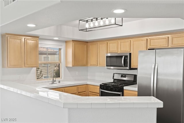 3608 Quetonia St Unit 204, Las Vegas, NV 89108 - kitchen featuring appliances with stainless steel finishes, light brown cabinets, tile countertops, a peninsula, and recessed lighting