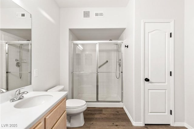3608 Quetonia St Unit 204, Las Vegas, NV 89108 - full bathroom featuring vanity, a stall shower, and wood finished floors