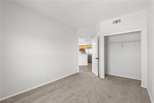3608 Quetonia St Unit 204, Las Vegas, NV 89108 - unfurnished bedroom with carpet flooring, freestanding refrigerator, and a closet