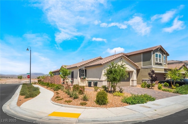 2845 Mincio St, Henderson, NV 89044 - mediterranean / spanish-style home with stucco siding, a tile roof, driveway, and a garage