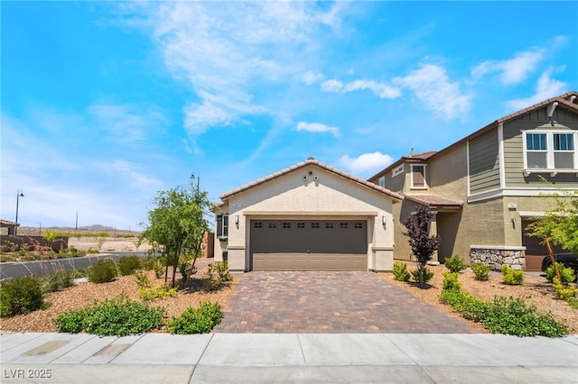 2845 Mincio St, Henderson, NV 89044 - view of front of property featuring stucco siding, decorative driveway, a garage, and a tiled roof