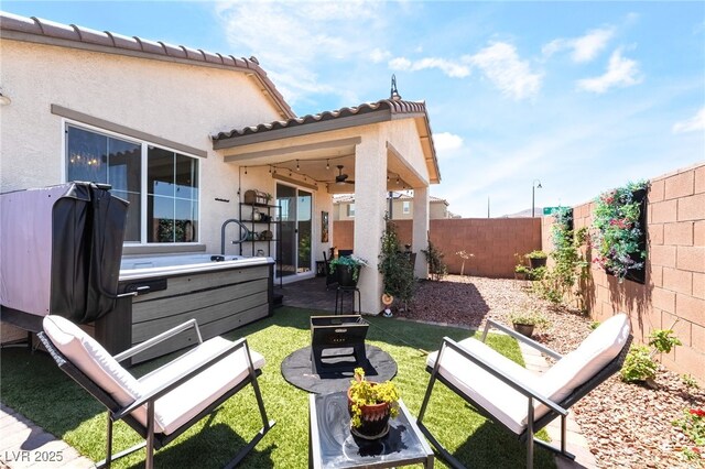 2845 Mincio St, Henderson, NV 89044 - fenced backyard with a ceiling fan, a patio area, and a hot tub