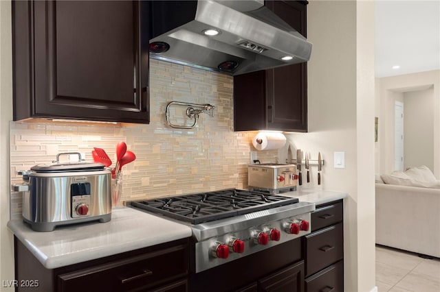 6810 Silver Crescent St, Las Vegas, NV 89148 - kitchen featuring wall chimney range hood, stainless steel gas stovetop, light countertops, decorative backsplash, and dark brown cabinets