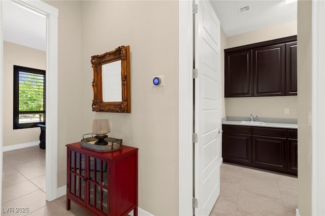 6810 Silver Crescent St, Las Vegas, NV 89148 - corridor with baseboards and light tile patterned floors