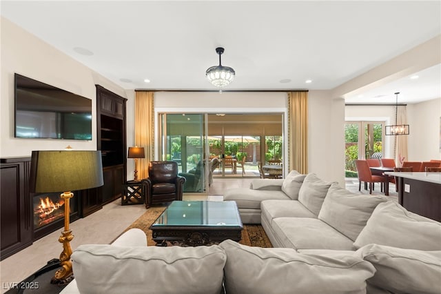 6810 Silver Crescent St, Las Vegas, NV 89148 - living room featuring a chandelier, light carpet, and recessed lighting